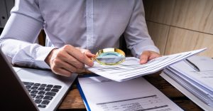 Blue Falcons Investigation private investigator analyzing financial records to uncover fraud, providing professional and confidential financial investigation services in North Carolina.