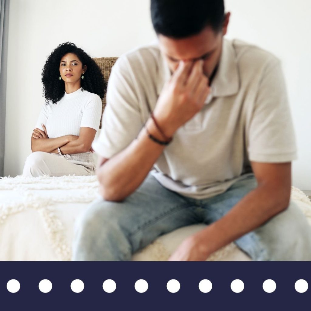 Couple sitting apart on bed representing suspected infidelity in North Carolina – Blue Falcons Investigation